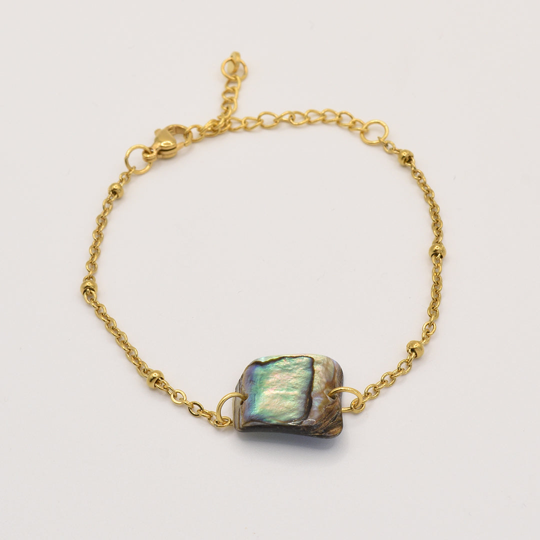 The Salty Dreamers Bracelet | Paua Shell Pae is a delicate gold chain bracelet with an iridescent rectangular pāua shell centerpiece, handmade in New Zealand—a stunning piece of jewelry photographed on a plain white background.