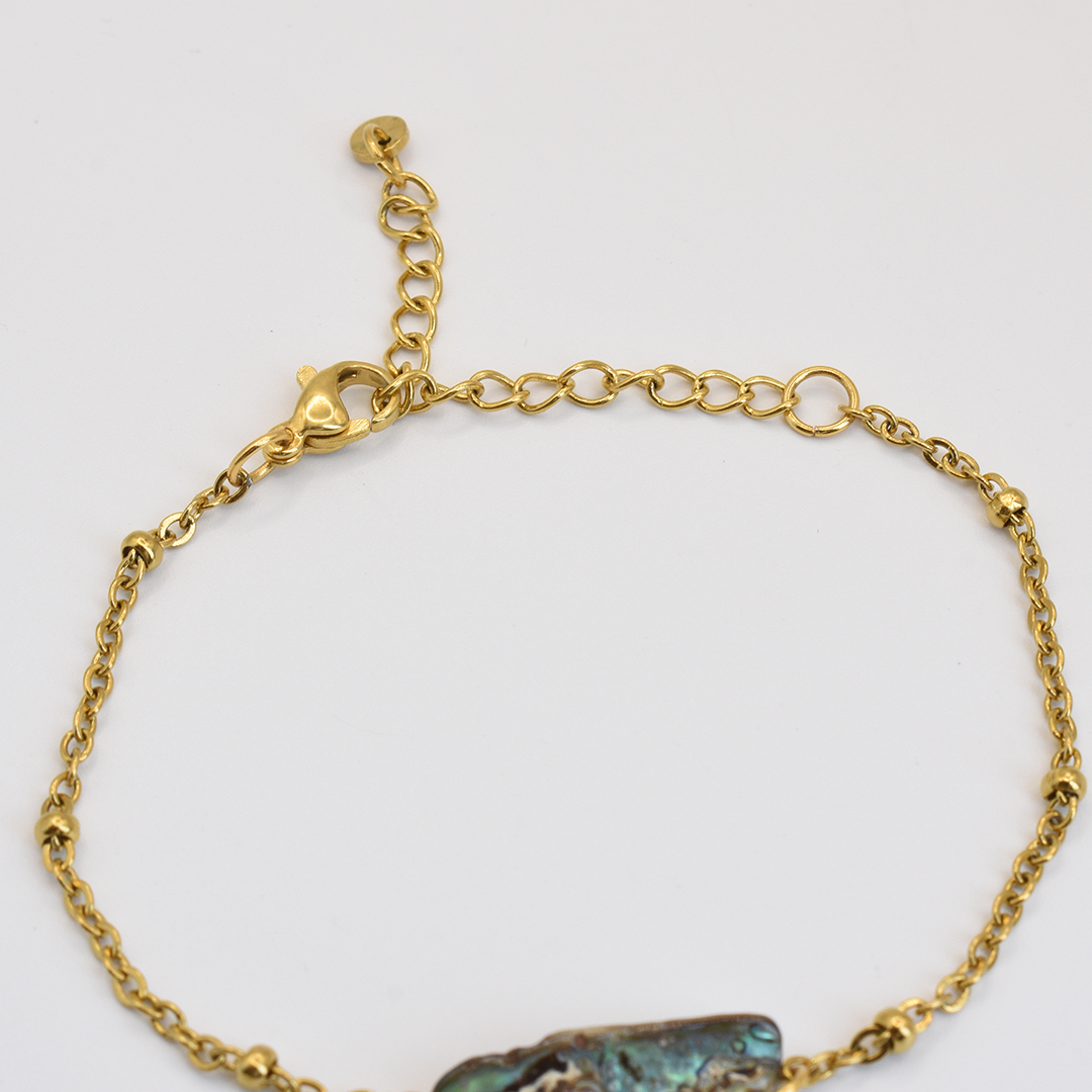 The Salty Dreamers Bracelet | Paua Shell Marie is a delicate gold chain bracelet with an adjustable clasp and pāua shell accent, shown on a white background.