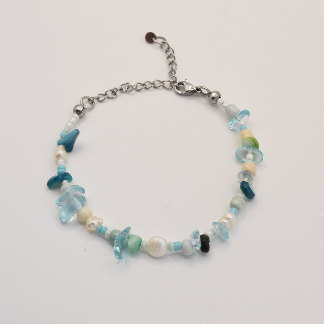 The Salty Dreamers Bracelet | Ocean Bamboo Blue features blue, green, and white stones and pearls, with a silver chain extender and lobster clasp, shown on a white background.