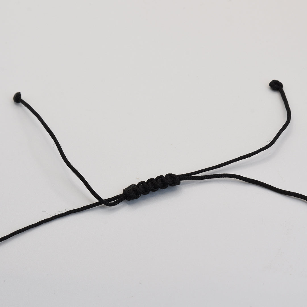 The Salty Dreamers Necklace | Paua Shell Haeata features a handmade black cord with an adjustable sliding knot, inspired by classic New Zealand jewelry design. Displayed on a plain white background with curved ends for a simple, elegant look.