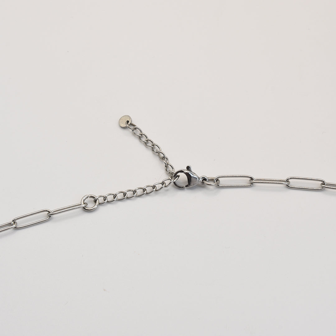 The Salty Dreamers Necklace | Paua Shell Tu features silver stainless steel elongated chain links, a lobster clasp, and an adjustable extension chain with a round end, displayed on a white background.