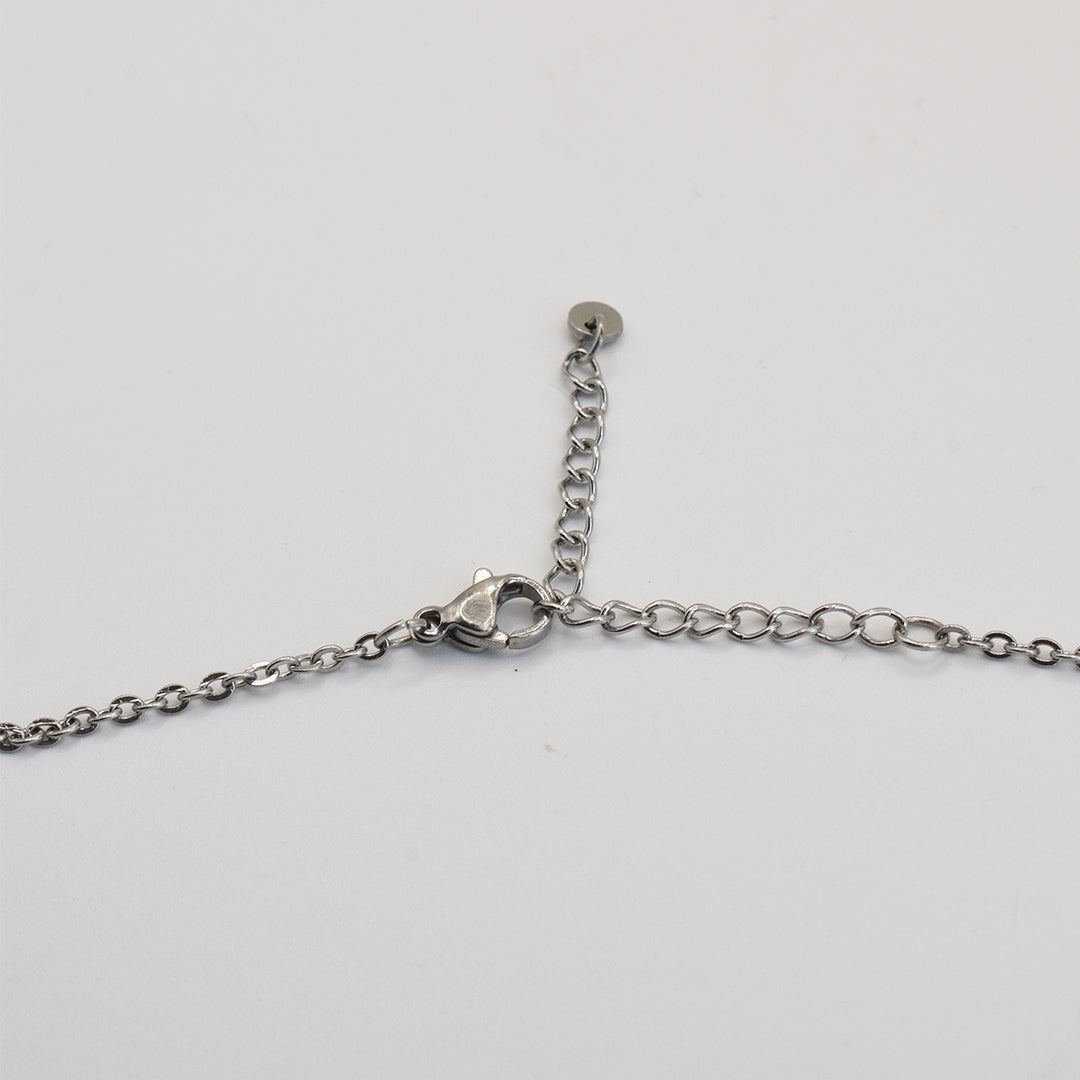 A close-up of the Salty Dreamers Necklace | Paua Shell Pae, a handmade piece with a silver chain, lobster clasp, and extension chain, elegantly displayed on a white background—unique New Zealand jewelry.