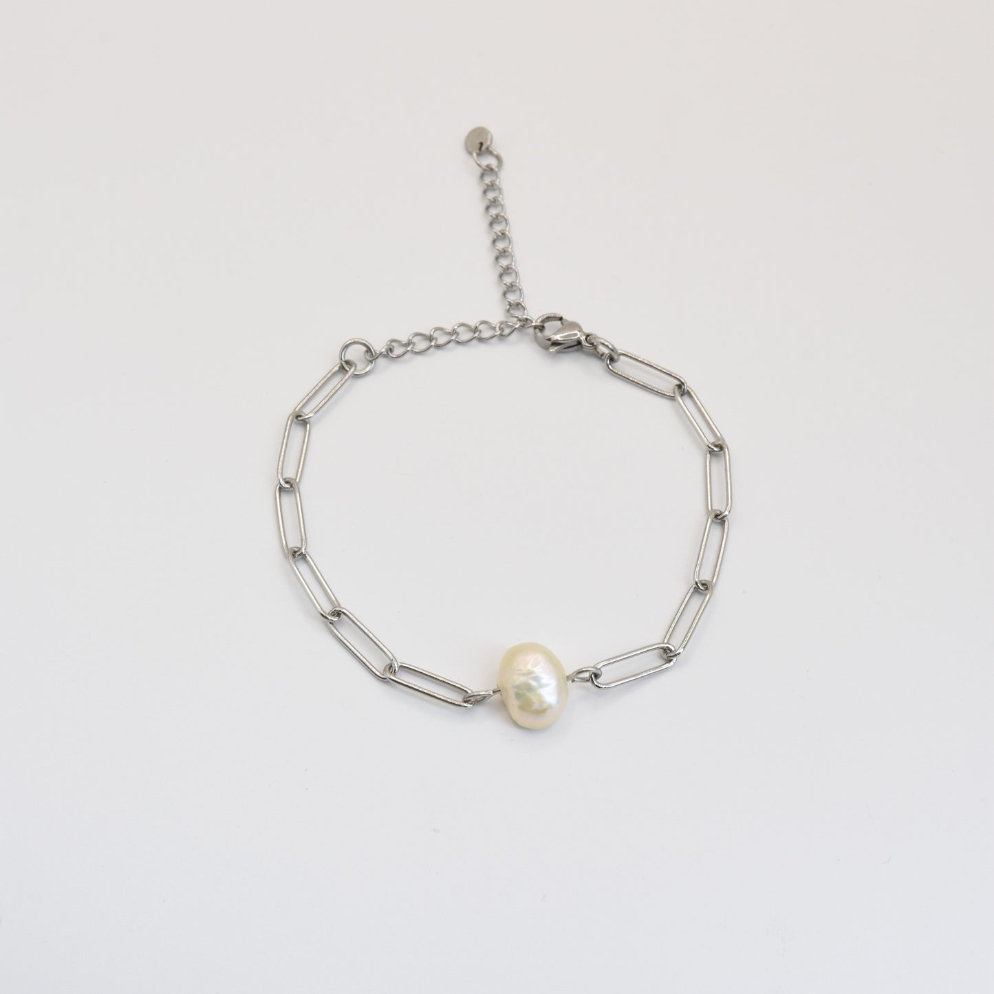 The Bracelet | Paperclip Cutie Silver by Salty Dreamers features elongated silver links and a central freshwater pearl, shown against a plain white background.