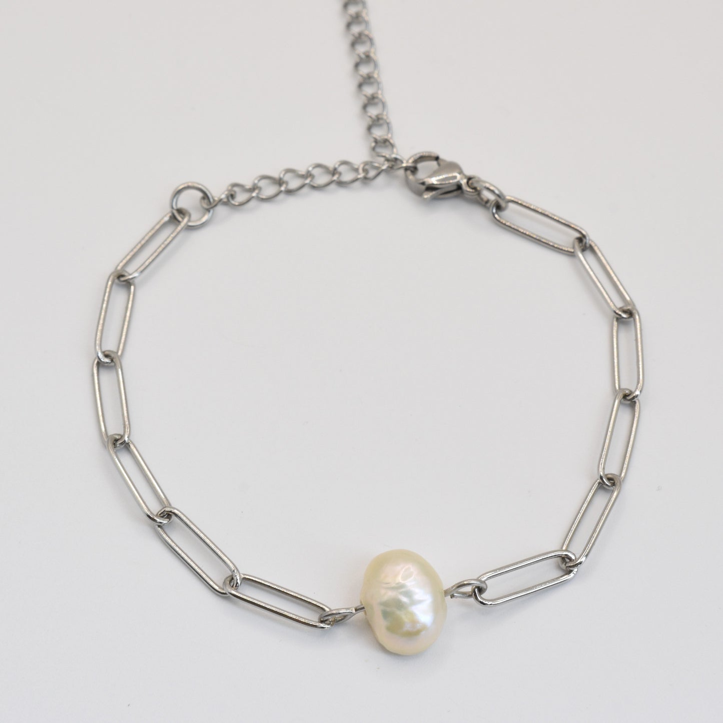 The Salty Dreamers Bracelet | Paperclip Cutie Silver features elongated silver links and a single freshwater pearl accent, elegantly handmade and shown on a plain white background.