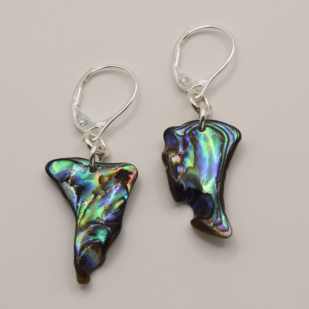 Salty Dreamers Earrings | Paua Shell Toroa feature handmade pāua shell pendants in irregular, iridescent blue, green, and purple tones on 925 silver hooks, displayed against a plain light background.