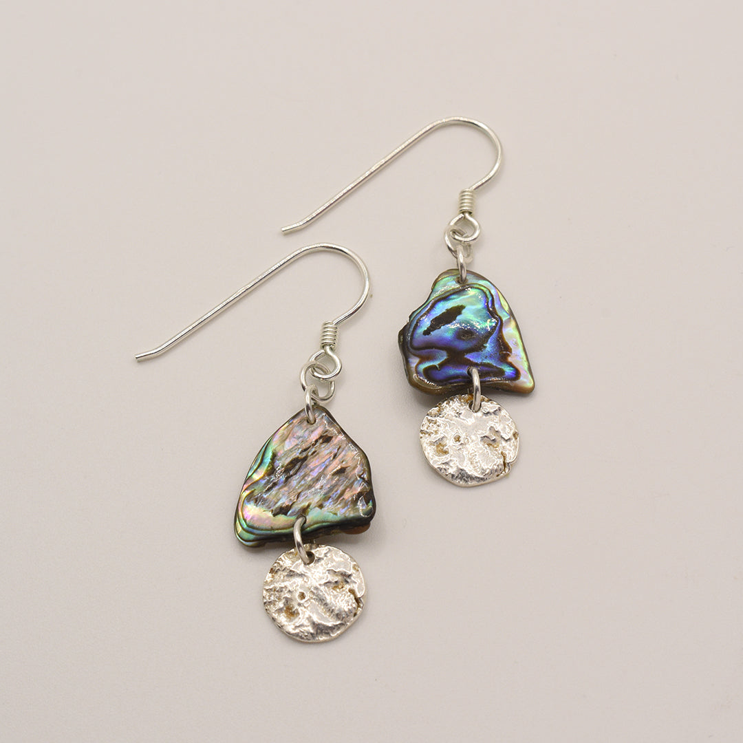 Salty Dreamers Earrings | Paua Shell Kekeno feature handmade iridescent New Zealand pāua shell and small round 925 silver charms, shown on a plain light background.