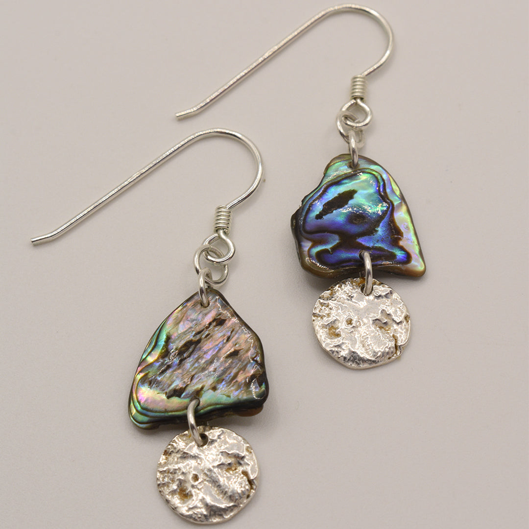 Salty Dreamers Earrings | Paua Shell Kekeno feature handcrafted, iridescent pāua shell pieces paired with round textured 925 silver discs on silver hooks.