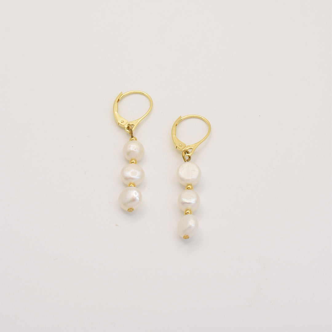 Salty Dreamers Prettiest Pearly earrings: gold leverbacks with three white freshwater pearls stacked vertically, handmade for elegant, ocean-inspired charm.