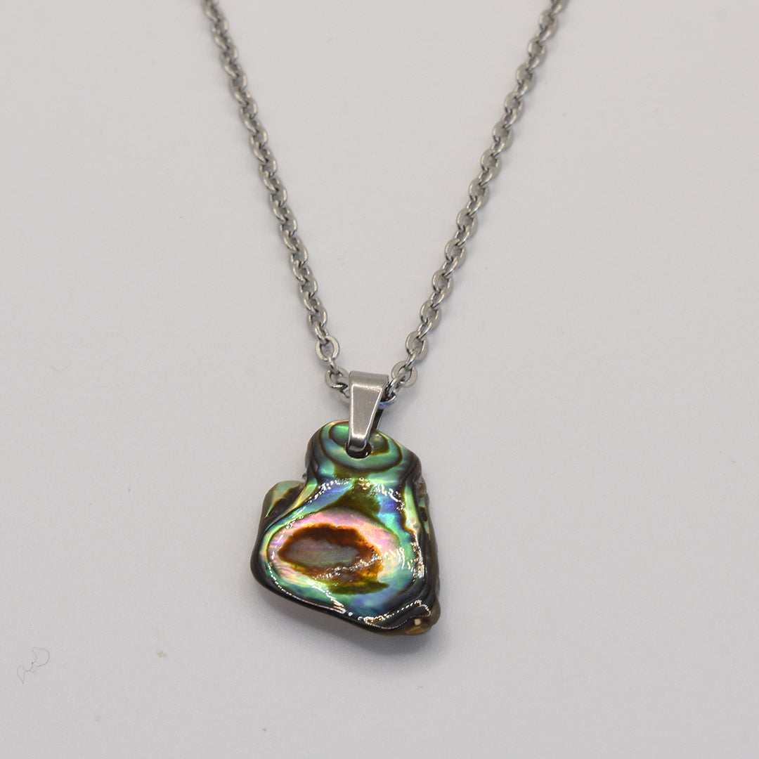 The Salty Dreamers Necklace | Paua Shell Mahaki features a silver chain and an iridescent paua shell pendant in green, blue, and brown hues, shown on a plain white background.