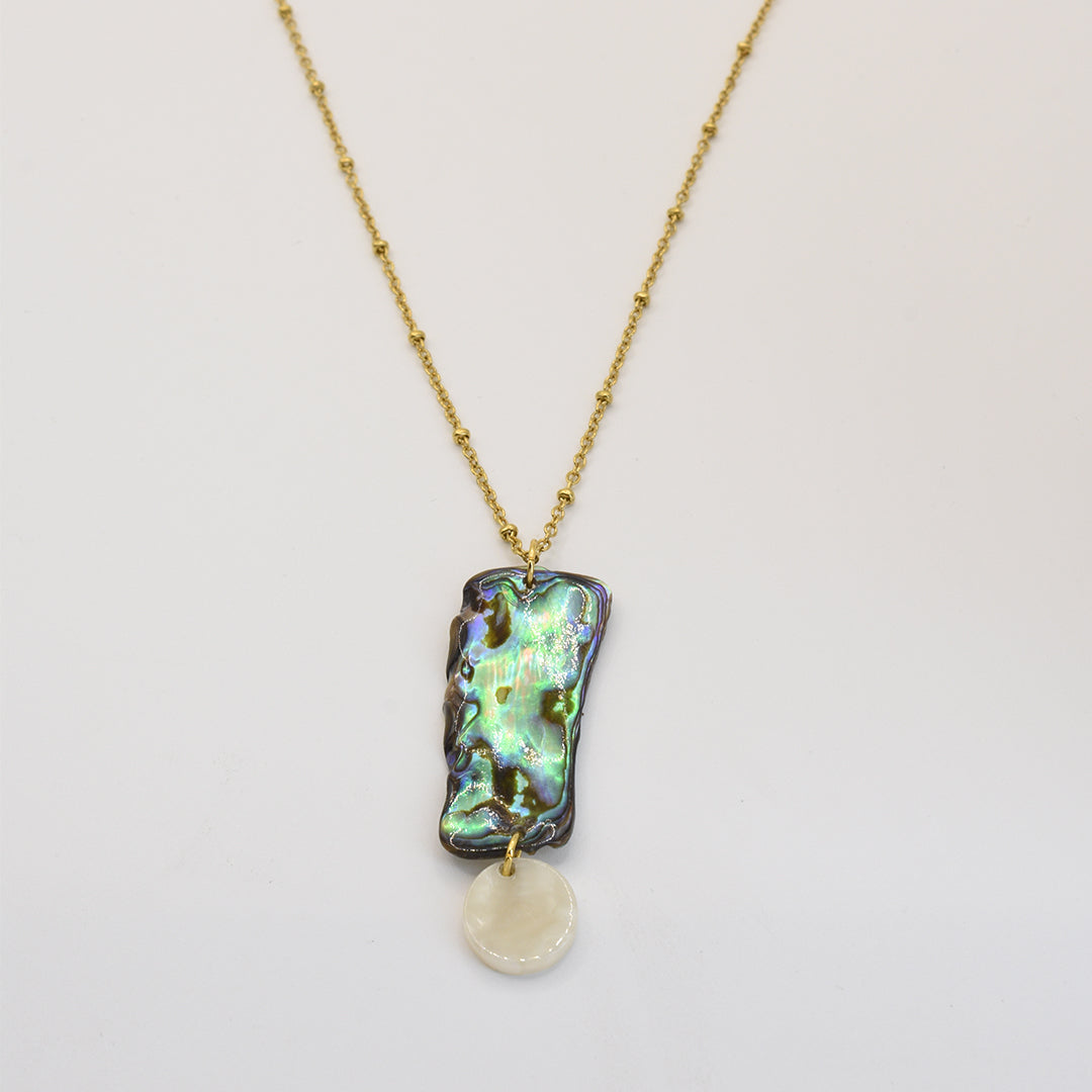 The Salty Dreamers Necklace | Paua Shell Hine features a handmade gold chain with a rectangular New Zealand abalone shell pendant and a small white shell charm, shown on a white background.