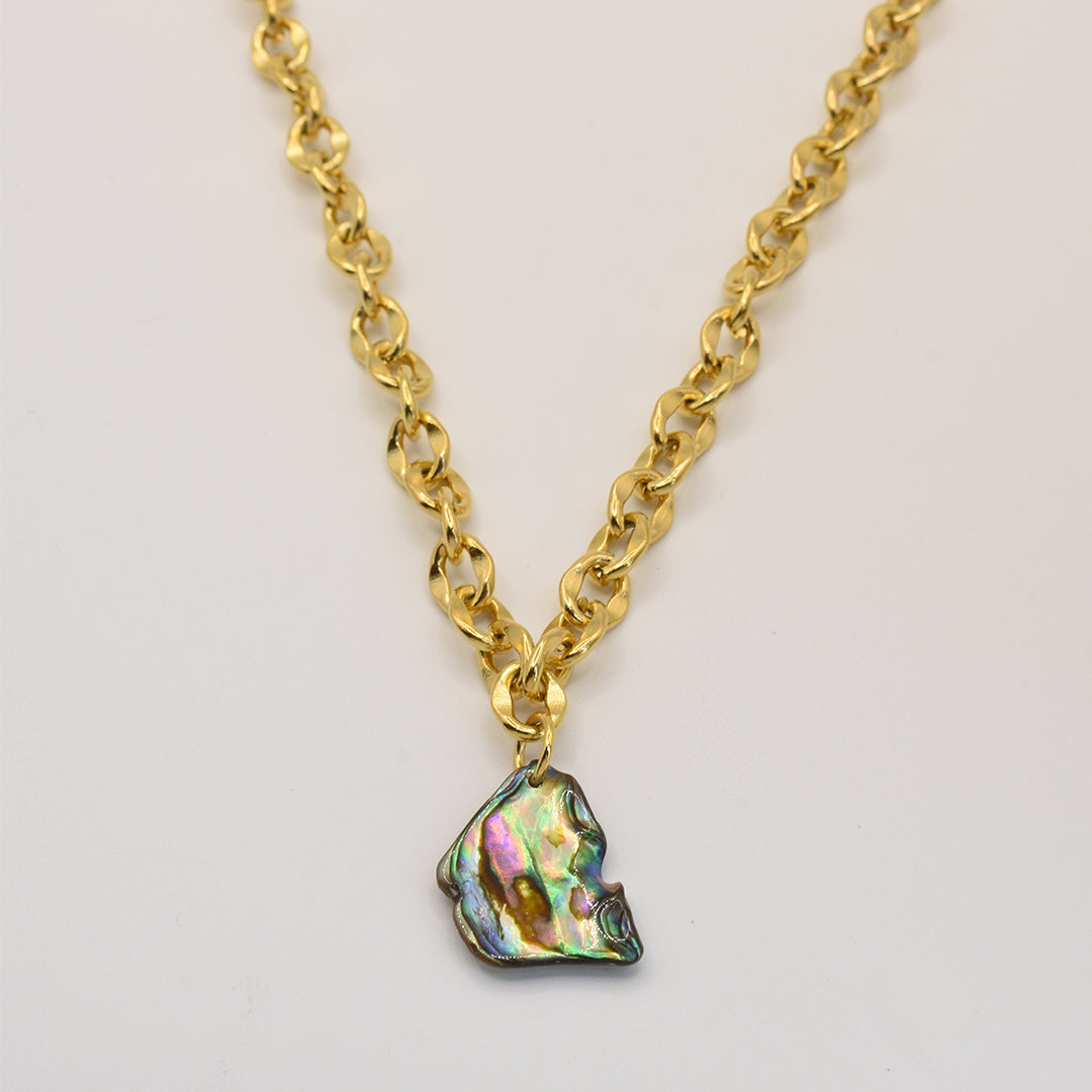 The Necklace | Paua Shell Rere by Salty Dreamers features a gold chain and a statement paua shell pendant with green, pink, and purple hues, shown on a plain light background.