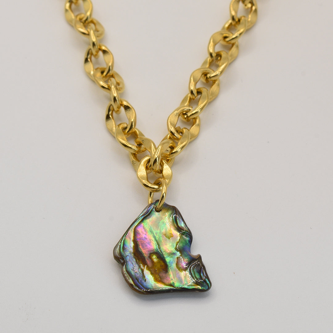 The Necklace | Paua Shell Rere by Salty Dreamers features a gold chain with a large, iridescent, irregular-shaped paua shell pendant—ideal for those who love unique handmade jewelry.