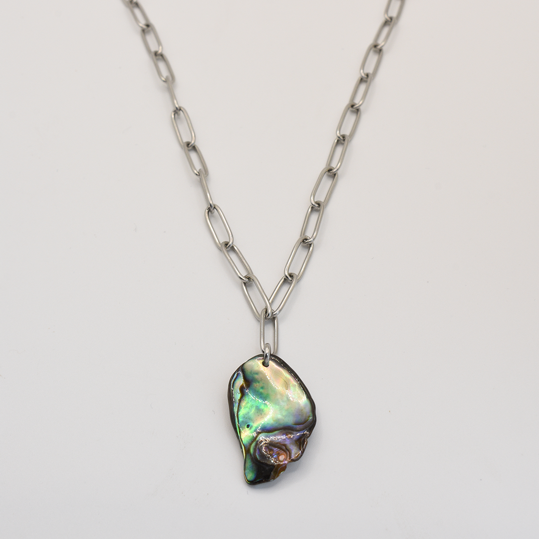 The Salty Dreamers Necklace | Paua Shell Tu features a handmade pāua shell abalone pendant on a bold silver chain, shown against a plain white background.