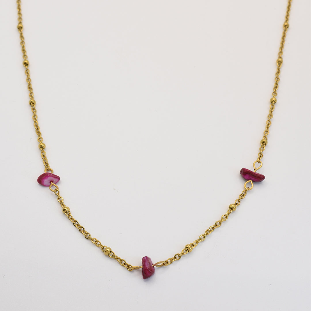 The Salty Dreamers Necklace | Shell Rubin is a delicate gold chain with three irregular pink stones, handmade and shown on a white background.