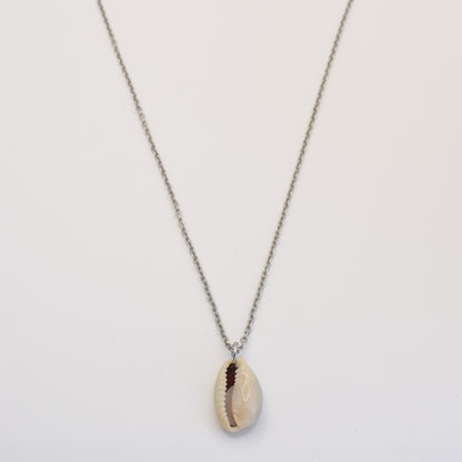 The Necklace | Simplified Cowrie Silver by Salty Dreamers features a handmade silver chain with a single cowrie pendant, beautifully displayed against a plain white background.