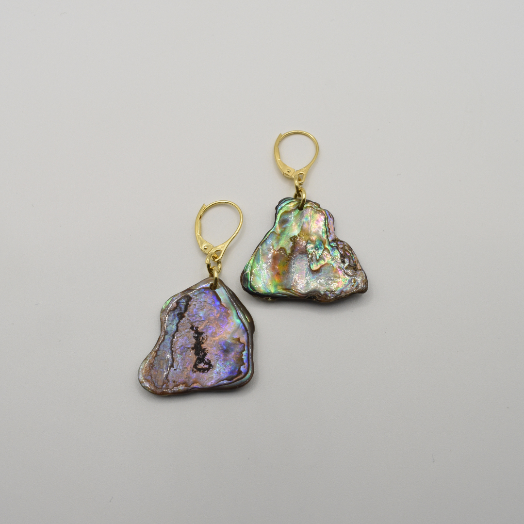 Salty Dreamers' Paua Shell Honu earrings feature handmade gold lever-backs with irregular iridescent New Zealand abalone pendants, shown on a plain white background.