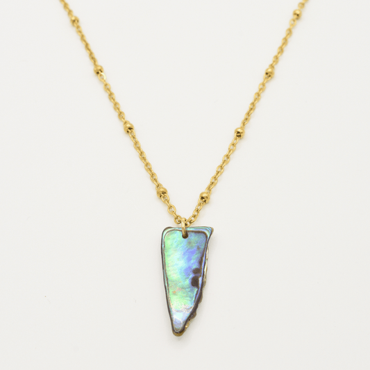 The Necklace | Paua Shell Hine by Salty Dreamers is a gold chain with textured beads and an iridescent New Zealand abalone shell pendant, set in gold. This handmade piece is beautifully shown on a white background.