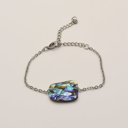 The Bracelet | Paua Shell Marama by Salty Dreamers is a handmade silver chain bracelet with a vibrant pāua shell centerpiece, inspired by New Zealand jewelry traditions and shown on a plain white background.