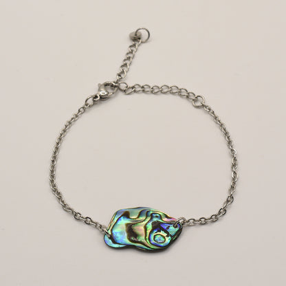 The Paua Shell Tumanako bracelet by Salty Dreamers is a handmade piece featuring a colorful pāua shell pendant, inspired by New Zealand jewelry traditions.