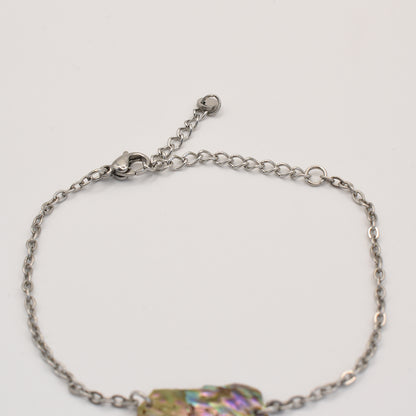 The Salty Dreamers Bracelet | Paua Shell Hine is a silver chain handmade bracelet with an adjustable clasp, shown on a white background. Part of an iridescent New Zealand paua shell accent is visible at the bottom edge.