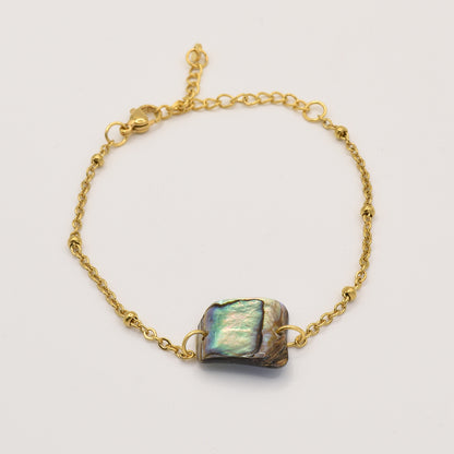 The Salty Dreamers Bracelet | Paua Shell Pae is a delicate gold chain bracelet with an iridescent rectangular pāua shell centerpiece, handmade in New Zealand—a stunning piece of jewelry photographed on a plain white background.