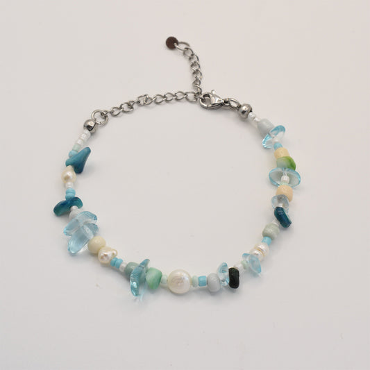 The Salty Dreamers Bracelet | Ocean Bamboo Blue features blue, green, and white stones and pearls, with a silver chain extender and lobster clasp, shown on a white background.