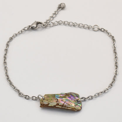 The Salty Dreamers Bracelet | Paua Shell Hine features a handmade silver chain with an iridescent, rectangular New Zealand paua shell centerpiece and lobster clasp, shown on a white background.