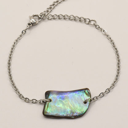 The Bracelet | Paua Shell Atarau by Salty Dreamers features a delicate silver chain and iridescent pāua shell centerpiece with a lobster clasp, showcasing elegant handmade New Zealand craftsmanship.