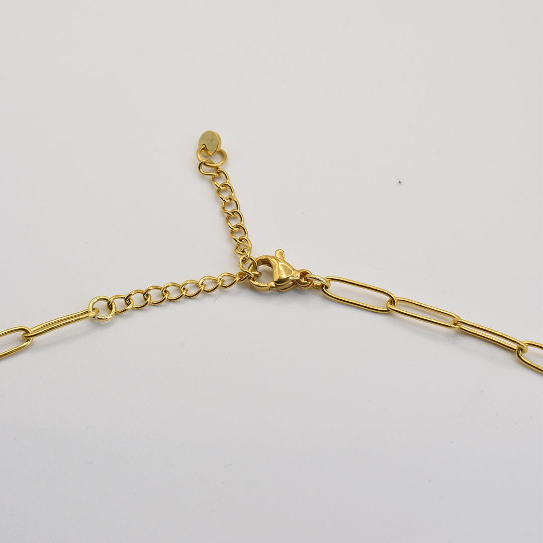 The Salty Dreamers Necklace | Paua Shell Tautahi features elongated gold links, an adjustable extension chain, and a lobster claw clasp, shown on a white background—perfect for layering with your favorite handmade pieces.