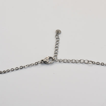 A close-up of the Salty Dreamers Necklace | Paua Shell Pae, a handmade piece with a silver chain, lobster clasp, and extension chain, elegantly displayed on a white background—unique New Zealand jewelry.