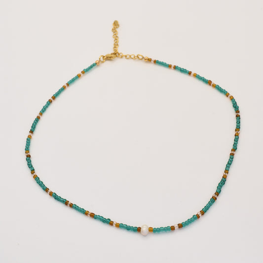 The Necklace | Fresh Beads Blue by Salty Dreamers is a handmade piece featuring turquoise, brown, and gold beads with a central freshwater pearl and an adjustable gold chain clasp, displayed on a white background.