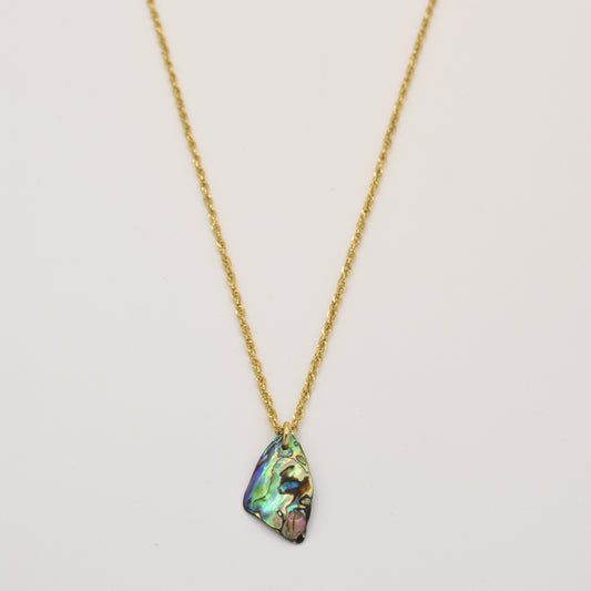 The Salty Dreamers Necklace | Paua Shell Kopiko is a golden stainless steel necklace with a handmade, iridescent teardrop paua shell pendant, shown against a plain white background.