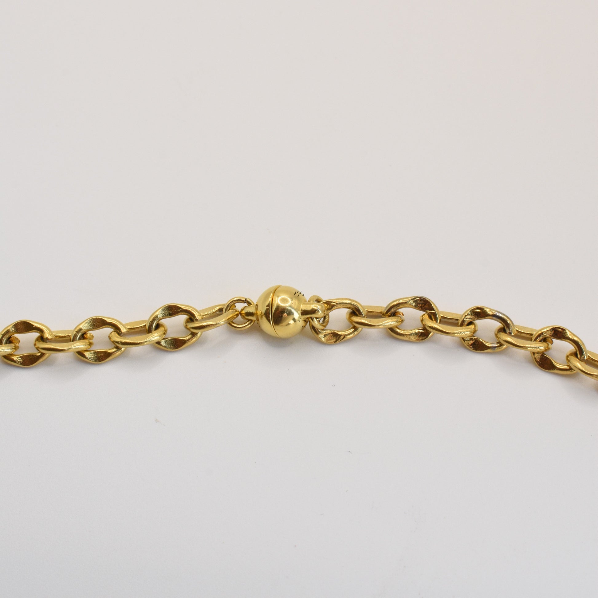 The Necklace | Ocean Dollar Gold by Salty Dreamers is a handmade gold chain with oval links and a round magnetic clasp, displayed on a white background.