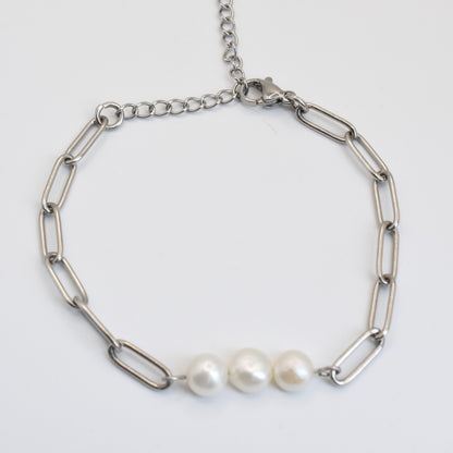 The Salty Dreamers Bracelet | Paperclip Pearly Silver is a handmade pearl bracelet with large oval silver links and three freshwater pearls at the center, perfect modern surfer jewelry, shown on a white background.