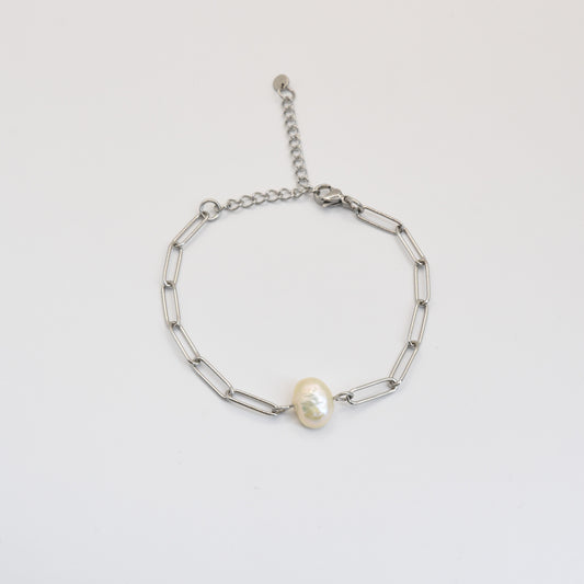 The Bracelet | Paperclip Cutie Silver by Salty Dreamers features elongated silver links and a central freshwater pearl, shown against a plain white background.