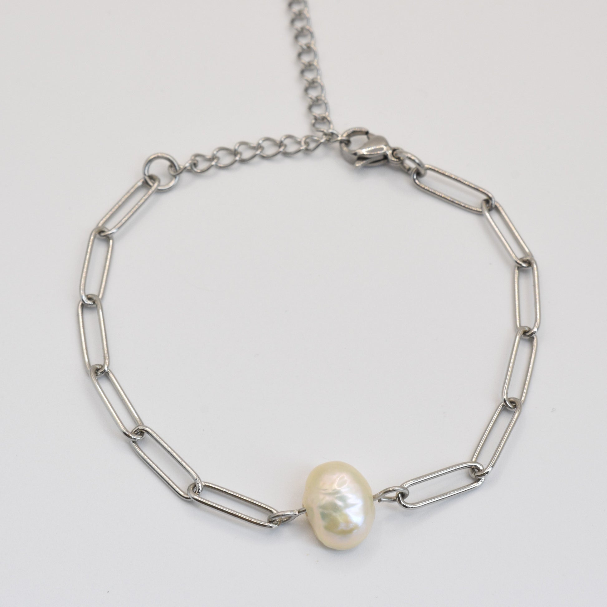 The Salty Dreamers Bracelet | Paperclip Cutie Silver features elongated silver links and a single freshwater pearl accent, elegantly handmade and shown on a plain white background.