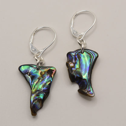 Salty Dreamers Earrings | Paua Shell Toroa feature handmade pāua shell pendants in irregular, iridescent blue, green, and purple tones on 925 silver hooks, displayed against a plain light background.