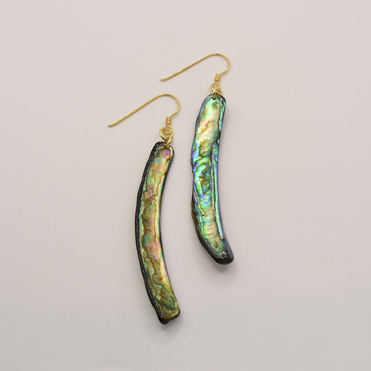 Salty Dreamers Earrings | Paua Shell Taurami feature long, curved handmade earrings with iridescent New Zealand pāua shell inlays set on gold hooks, shown against a plain light background.