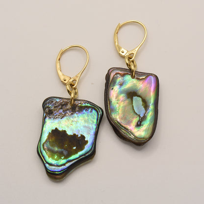 Salty Dreamers’ Earrings | Paua Shell Korohea feature handmade, iridescent pāua shell pendants with gold-plated 925-silver lever-back hooks, shown against a light backdrop.