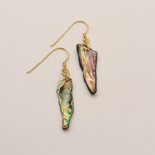 Salty Dreamers’ Paua Shell Mahaki earrings feature irregular, elongated New Zealand abalone pendants in iridescent green, pink, and gold tones, each hanging from a simple gold-plated silver hook.