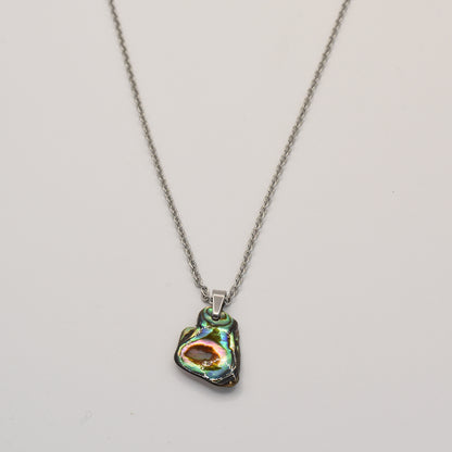 The Necklace | Paua Shell Mahaki by Salty Dreamers features a silver chain and a unique, iridescent pāua shell pendant, shown on a plain white background.