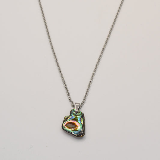 The Necklace | Paua Shell Mahaki by Salty Dreamers features a silver chain and a unique, iridescent pāua shell pendant, shown on a plain white background.