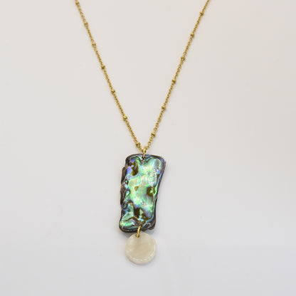 The Salty Dreamers Necklace | Paua Shell Hine features a handmade gold chain with a rectangular New Zealand abalone shell pendant and a small white shell charm, shown on a white background.