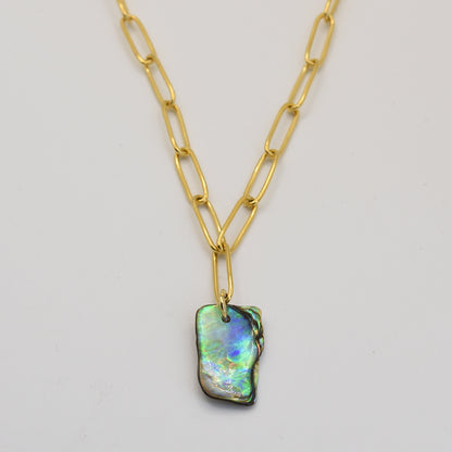 The Salty Dreamers Necklace | Paua Shell Tautahi features large gold links and a rectangular iridescent pāua shell pendant—a stunning handmade jewelry piece shown on a plain white background.