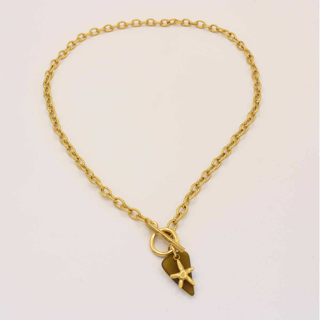 The Salty Dreamers Necklace | Star Sea Glass features a golden stainless steel chain with an irregular gold pendant, adorned with a small star detail, shown on a plain white background.