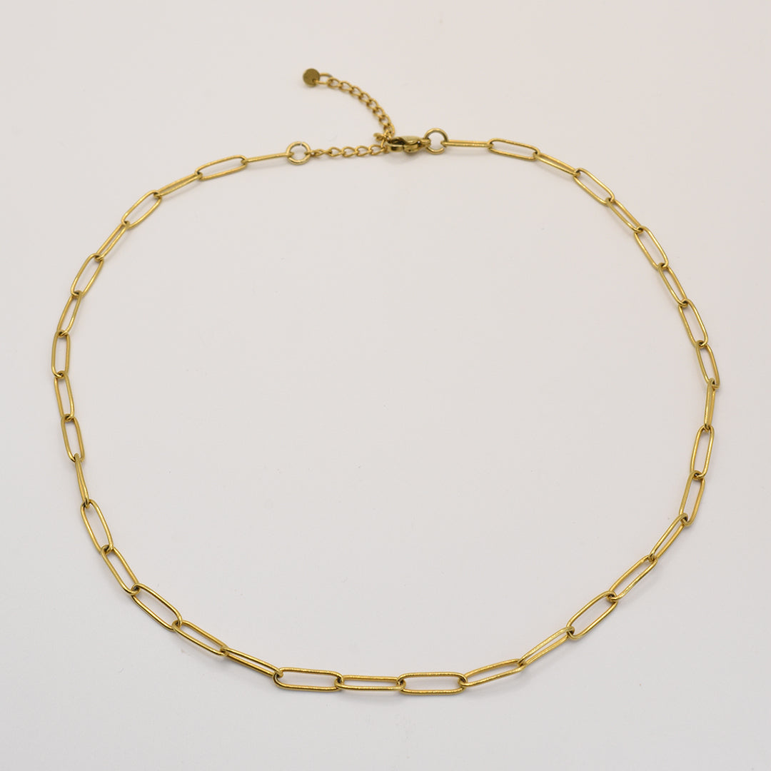 The Golden Vibes necklace by Salty Dreamers showcases handmade elongated oval links and an adjustable clasp in gold stainless steel, displayed against a plain white background.