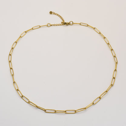The Golden Vibes necklace by Salty Dreamers showcases handmade elongated oval links and an adjustable clasp in gold stainless steel, displayed against a plain white background.