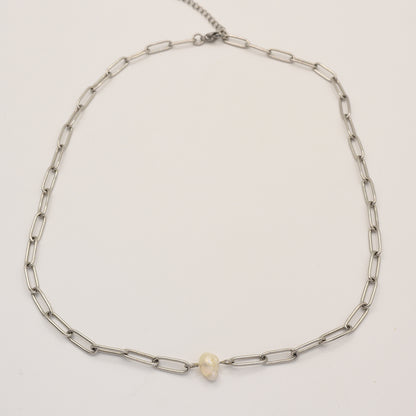 The Salty Dreamers Necklace | Paperclip Cutie Silver features elongated silver links and a single small freshwater pearl at the center, elegantly showcased on a plain white background.