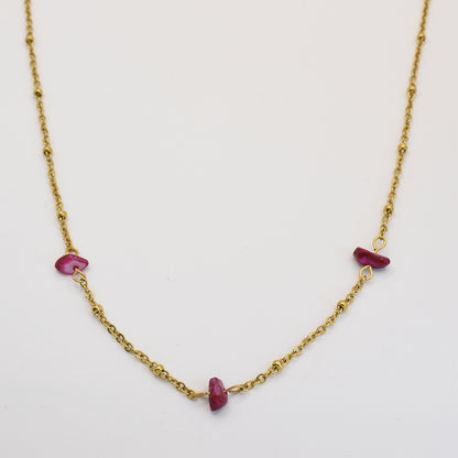 The Salty Dreamers Necklace | Shell Rubin is a delicate gold chain with three irregular pink stones, handmade and shown on a white background.