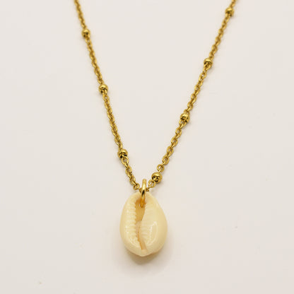 The Necklace | Simplified Cowrie Gold by Salty Dreamers features a handmade gold chain with a striking white cowrie pendant, elegantly displayed on a plain white background.